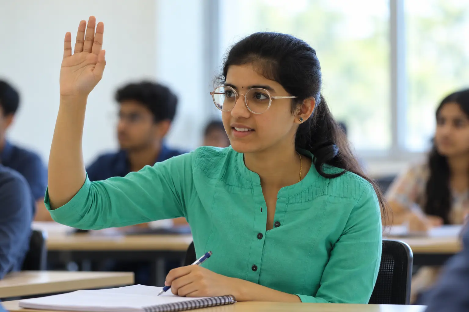 A PU student raising her hand to ask a question in class